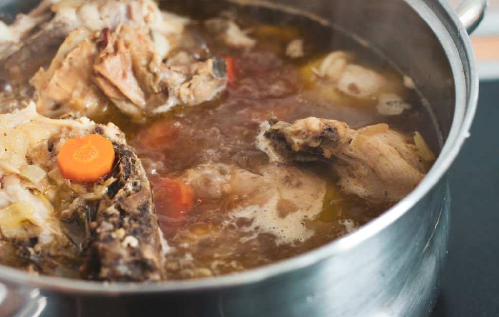 Chicken stock simmering on the stove.